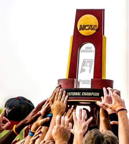 The baseball team holding up the NCAA DIII national championship.