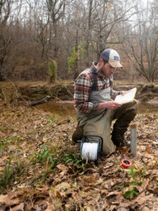 Environmental science Ben Haskett studies a paper report by College Lake