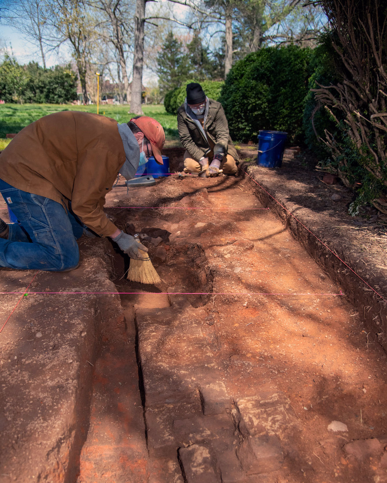 Two students brush dirt away at a dig at Historic Sandusky
