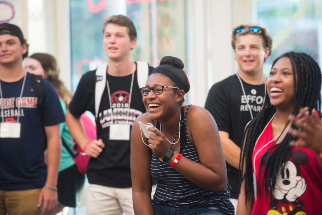 A group of student laugh during an ice breaker