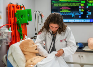 DVN_6015 PA student practicing on a simulation dummy.
