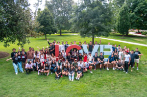 A group of international students take a group photo in front of the LOVE sculpture