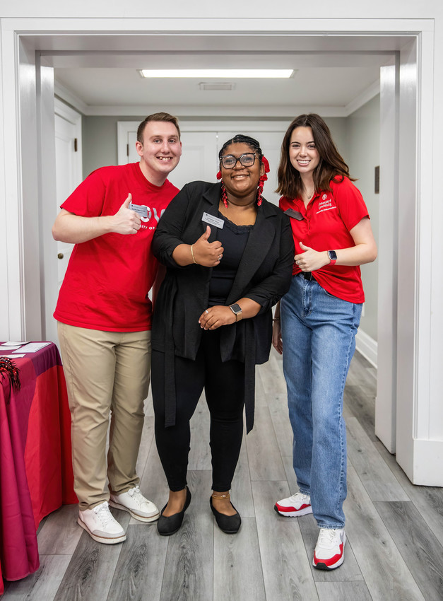 Three people giving a thumbs up.